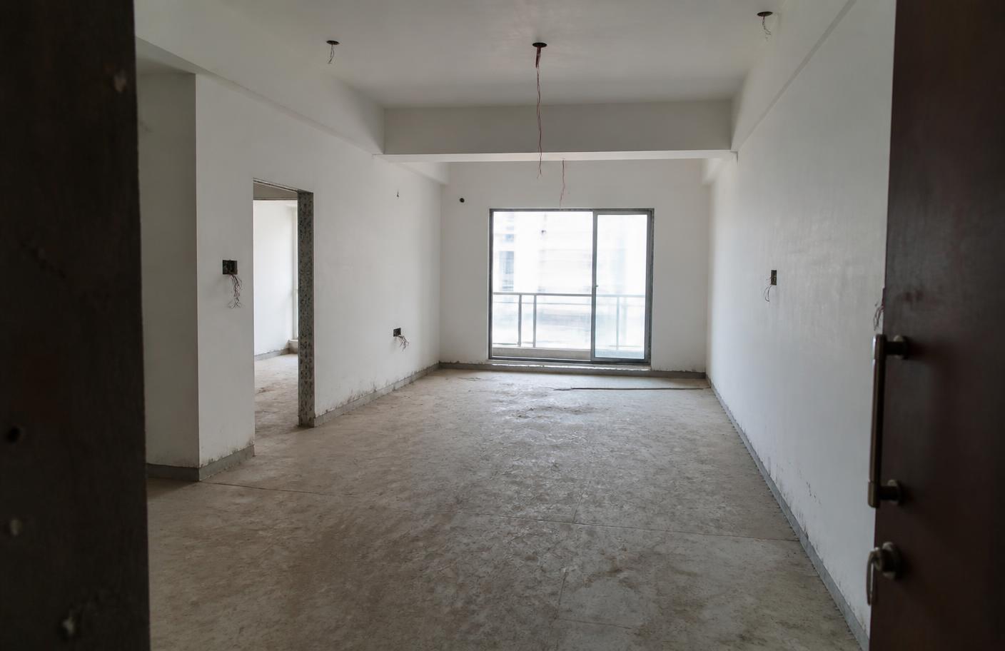 Empty unfinished apartment living room before renovation